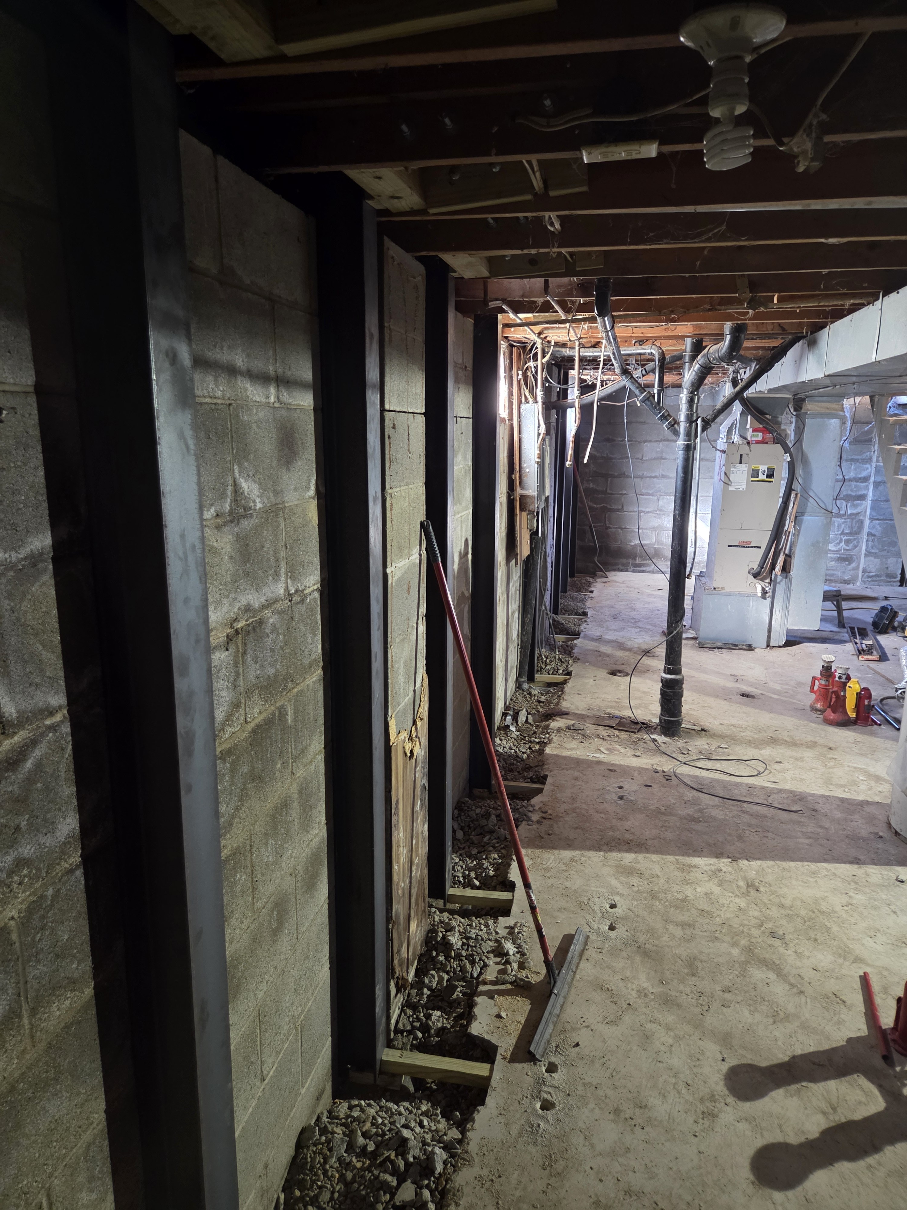Steel beam reinforcement installed along basement wall
